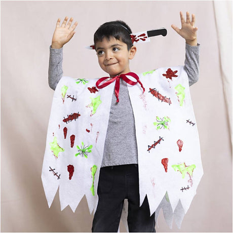 Child wearing a superhero cape with colorful designs on a plain background