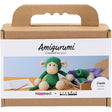 Amigurumi monkey kit packaging with cardboard box and green monkey toy inside