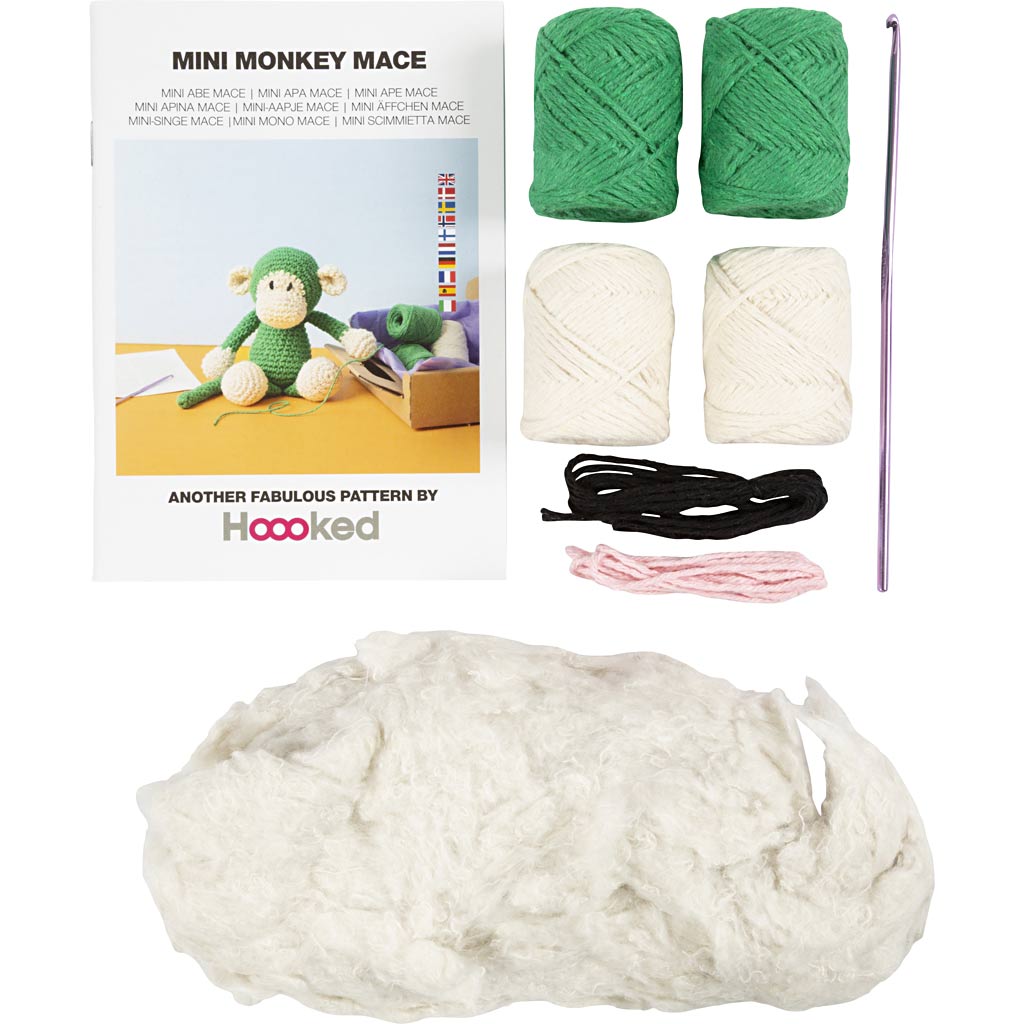Knitting kit with yarn, needles, and pattern book for creating a mini monkey mace by Hoooked.