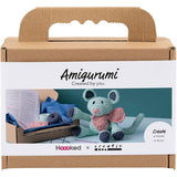 Amigurumi kit packaging with a crocheted mouse toy and crafting materials.