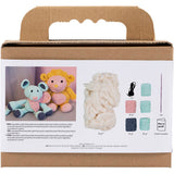 Cardboard box with yarn and crochet toys on a white background