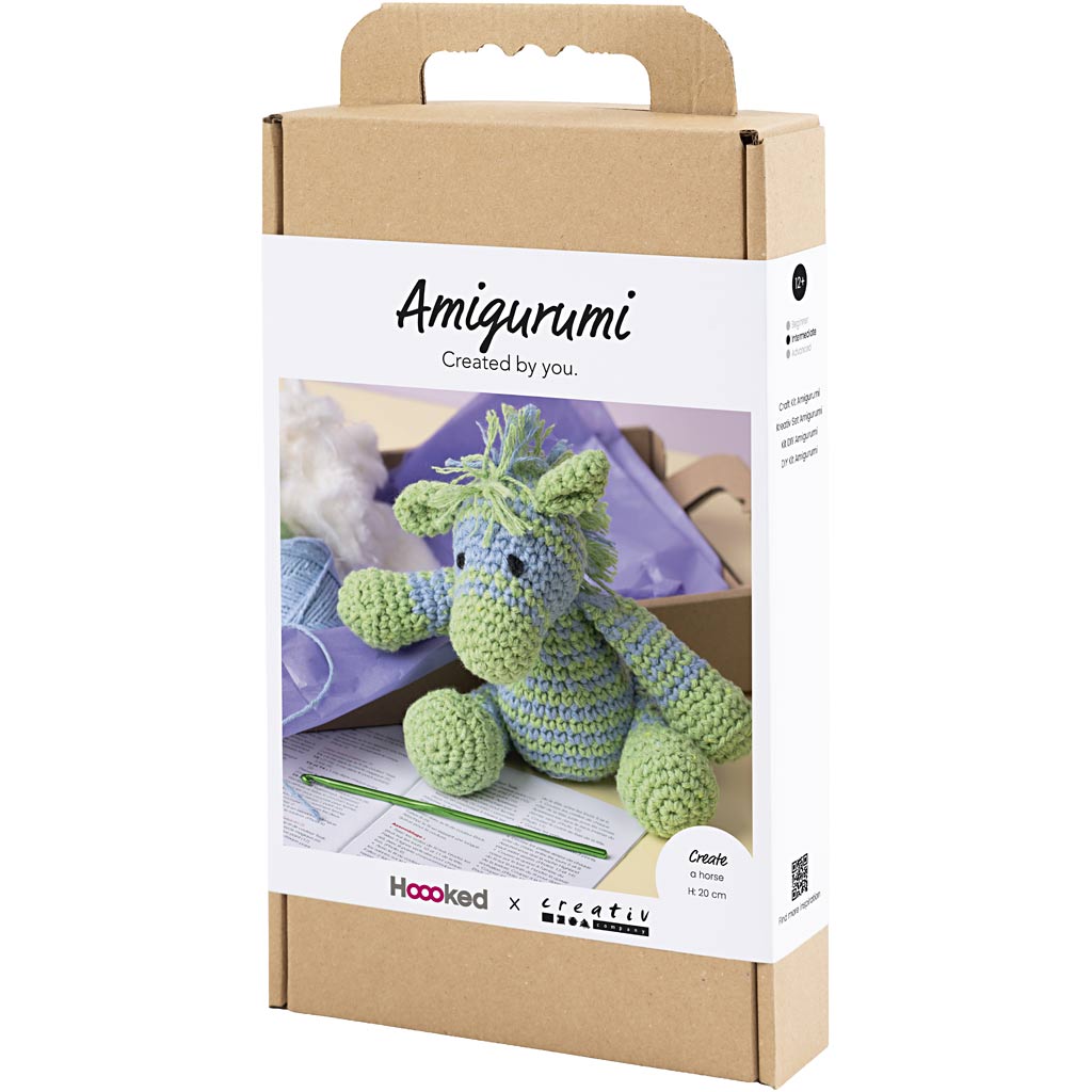 Amigurumi crochet kit packaging with a green dragon toy on a white background