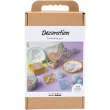 Cardboard packaging of a decoration craft kit with 'creativ' branding on a white background