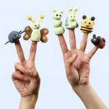 two hands with clay finger puppets in the shape of insects on 6 fingers on a white background
