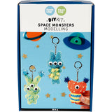 Box of DIY space monsters modelling kit with colorful monsters on a blue background
