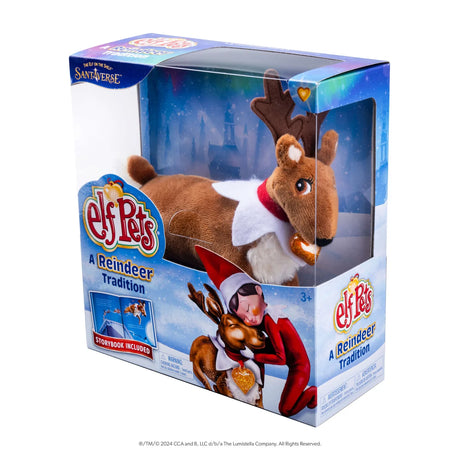 Elf Pets A Reindeer Tradition toy in its original retail packaging, featuring a plush reindeer dressed as Santa with a red Santa hat and white Santa coat, set against a snowy winter scene.