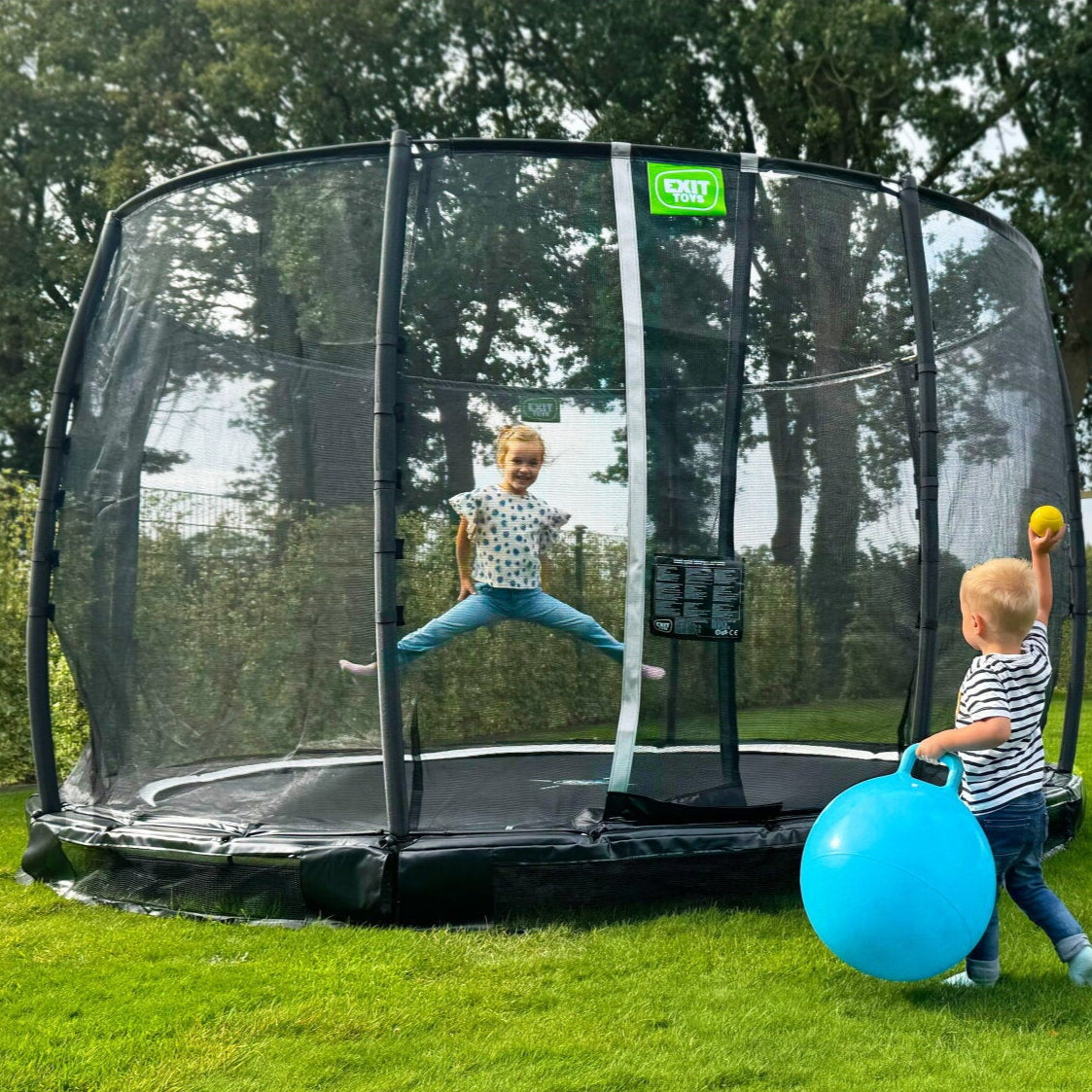 Exit Premium Ground Round Trampoline Black outside in the garden