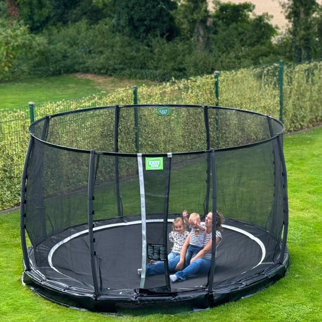 Exit Premium Ground Round Trampoline Black outside in the garden