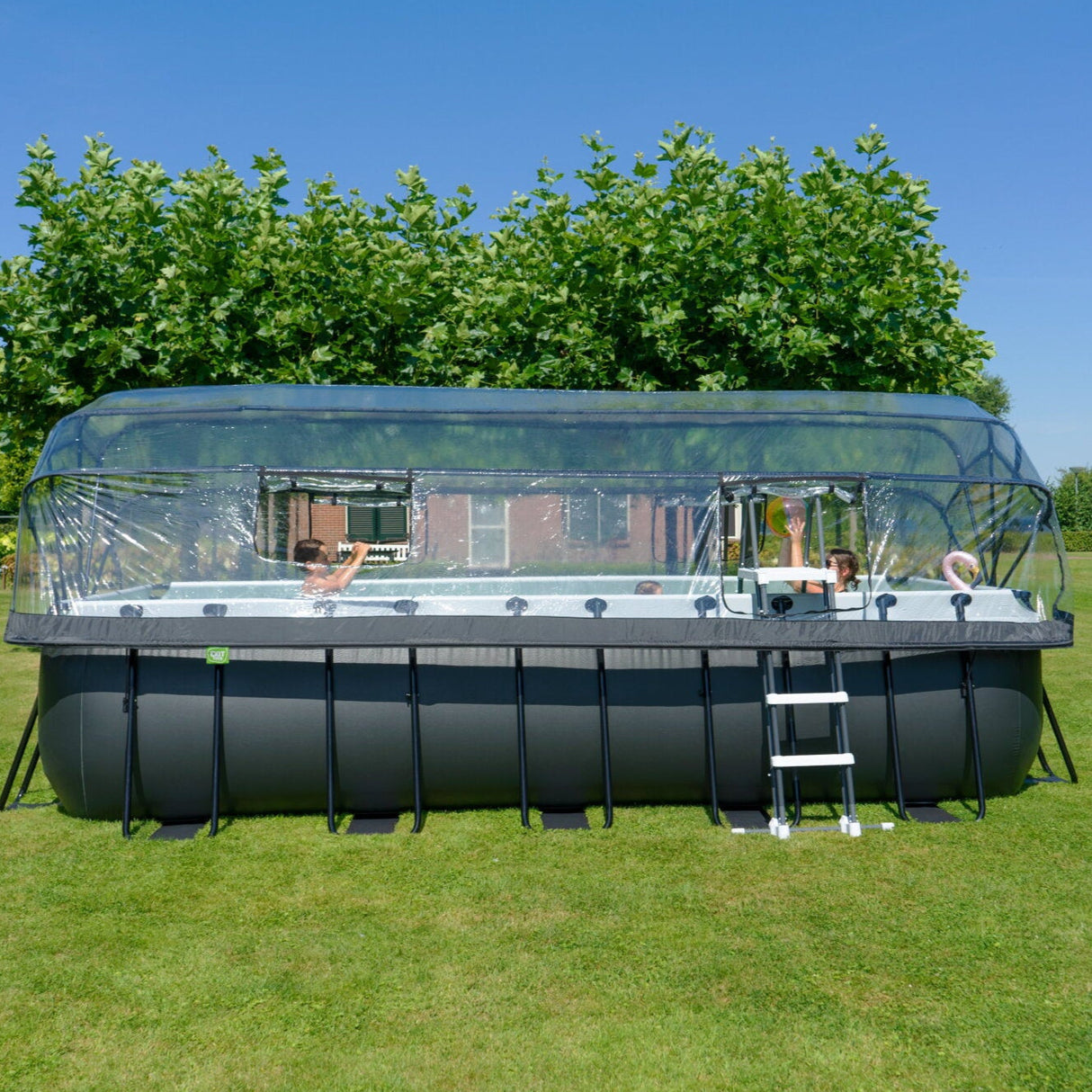 Children playing in an Exit Toys black leather pool in the garden