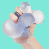 Hand holding a silicone stress ball with 'Swell' branding against a teal background