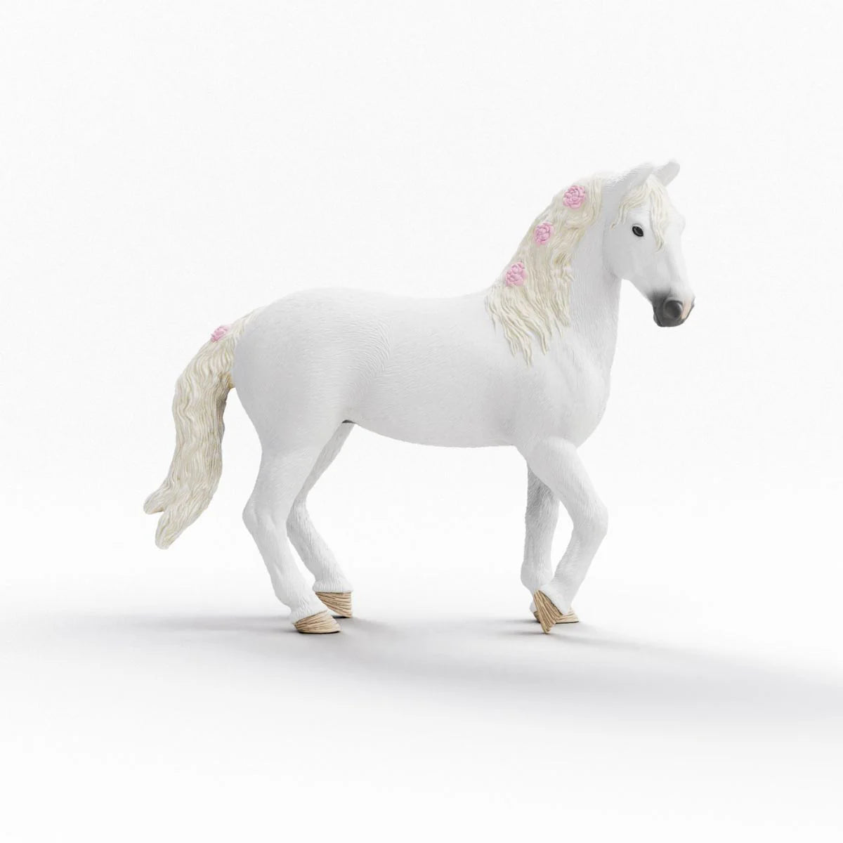 White horse figurine with decorative mane on a white background