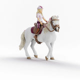 Model of a person riding a horse on a white background