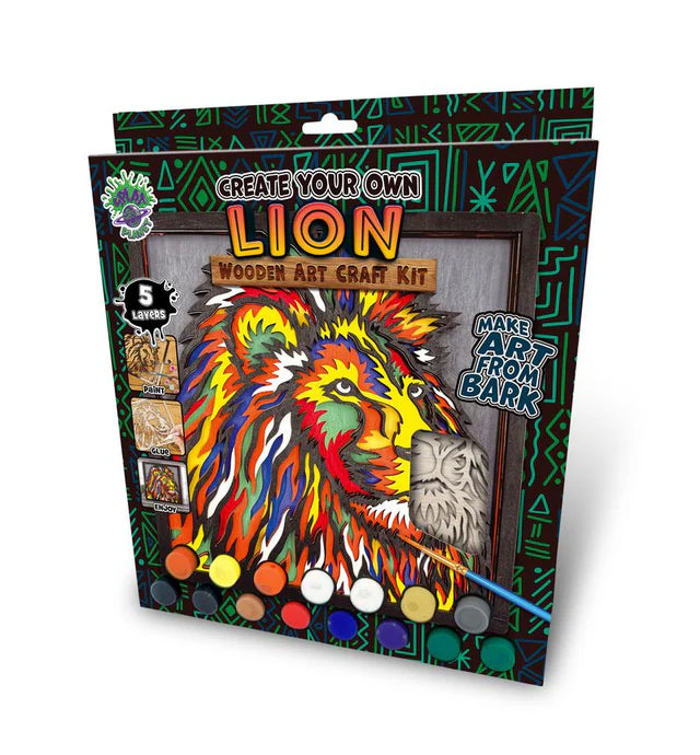 A packaged wooden art craft kit showing a colorful lion illustration on the front, with text reading 'Create Your Own Lion Wooden Art Craft Kit' and 'Make Art From Bark.' The box includes multiple color paint wells and small inset images of materials, photographed on a light gray background.