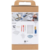 Cardboard box with kintsugi craft materials and tools on a white background