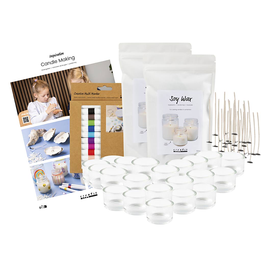 Candle making kit with wicks, containers, and supplies on a white background