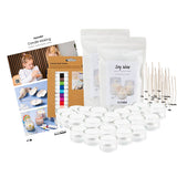 Candle making kit with wicks, containers, and supplies on a white background