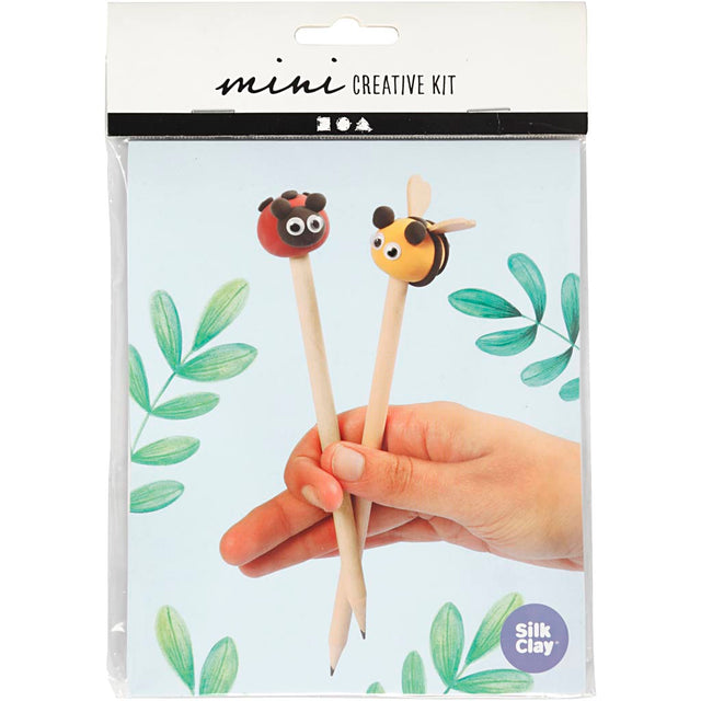 Silk Clay mini creative kit packaging with ladybug and bee-themed pencil toppers held by a hand.