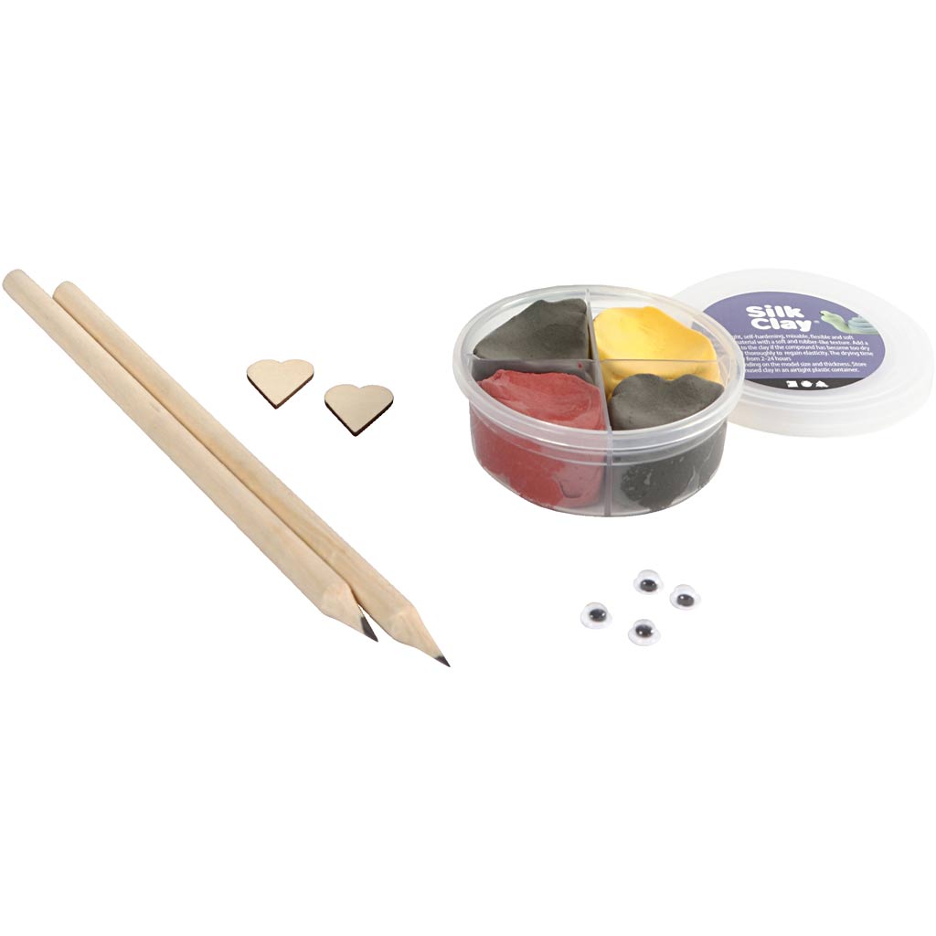 Silk Clay kit with containers, wooden pencils, and small heart-shaped items on a white background