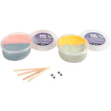 Silk Clay containers with colorful clay and tools on a white background