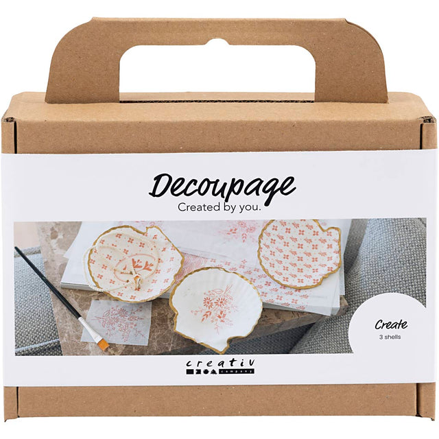 Decoupage kit packaging with decorative papers and tools on a white background