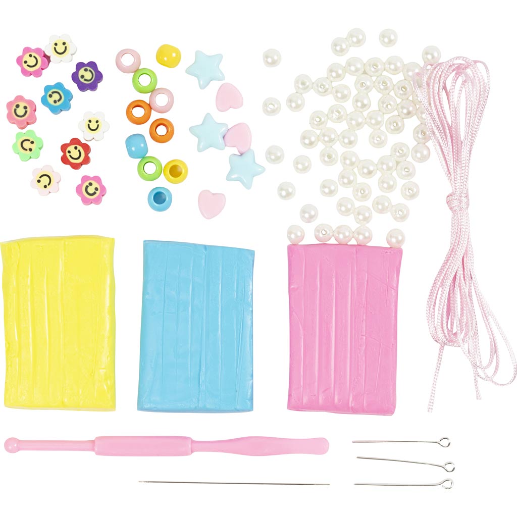 Assorted craft supplies including beads, string, and tools on a white background
