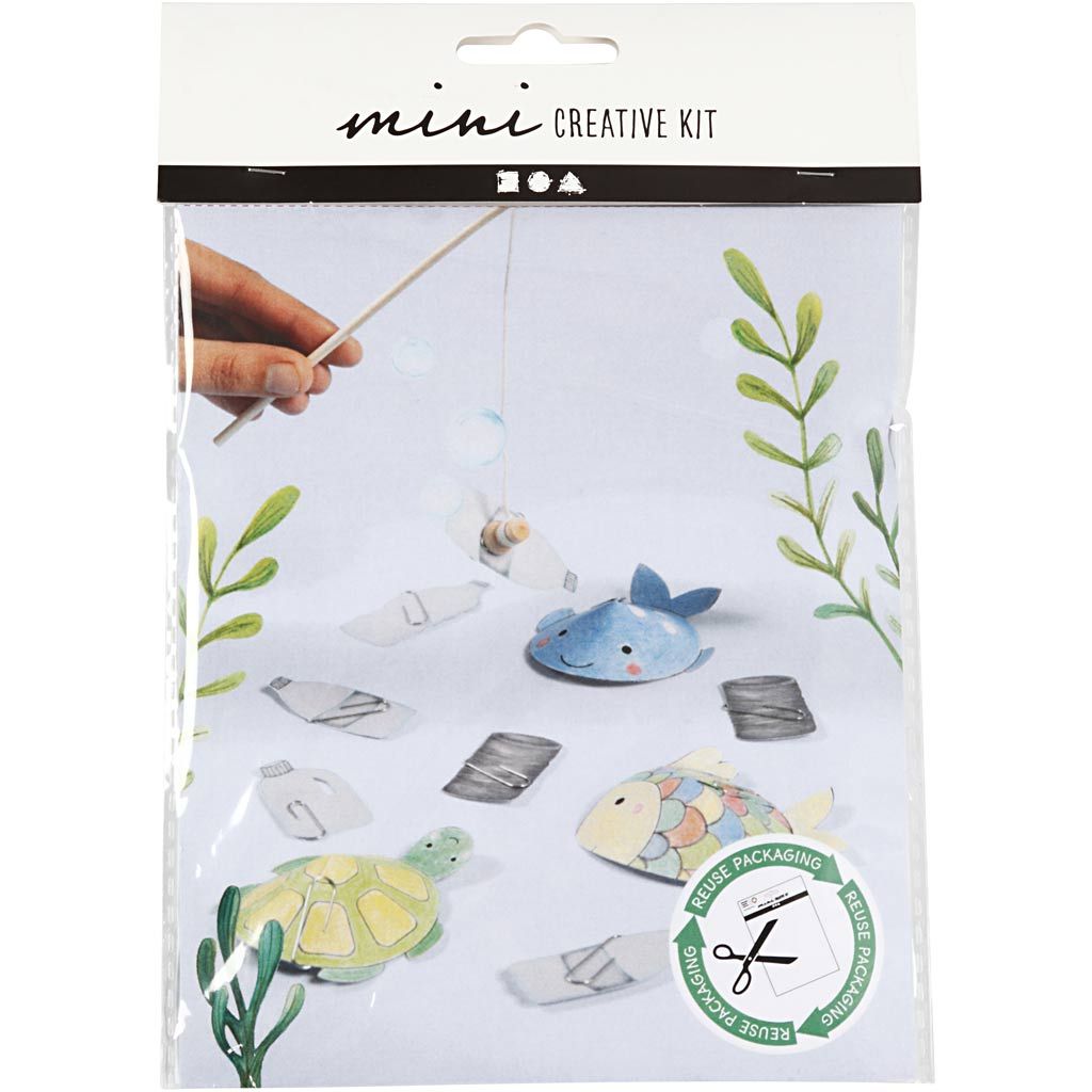 Mini creative kit packaging with sea-themed items and a hand holding a stick.