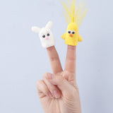 two fingers with a white finger puppet charachter and a yellow finger puppet character on a white background