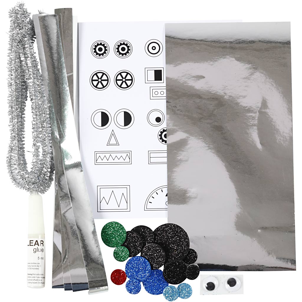 Collection of decorative items including a bottle, tinsel, and various shapes on a white background.