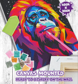 Colorful monkey diamond painting kit with tools and beads on a wooden surface
