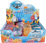 A retail display box filled with octopus squeeze balls. The display features colorful underwater-themed graphics with fish and coral, and the text 'DEEP WATER OCTOPUS SQUEEZE BALL WITH GLITTER!'.