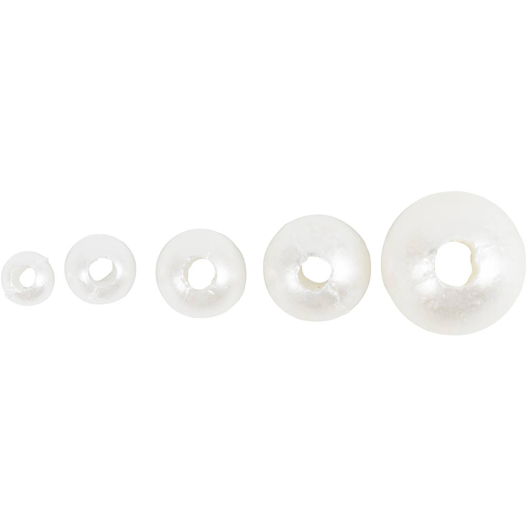 Set of five white wax beads of varying sizes on a white background