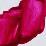 Close-up of a bright pink paint on a white background