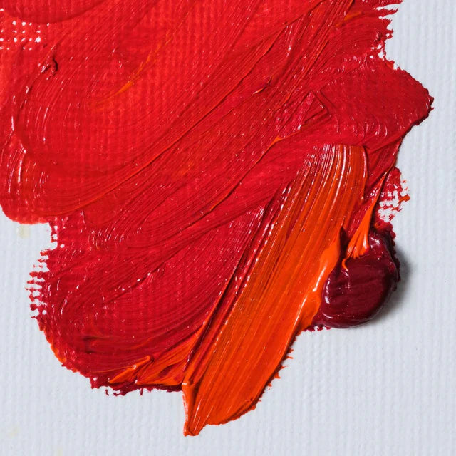 Close-up of red and orange paint swatches on a white background