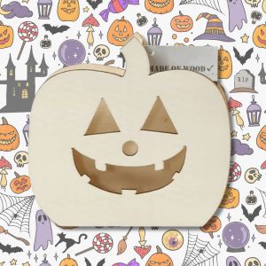 a wooden craft pumpkin on a halloween themed background