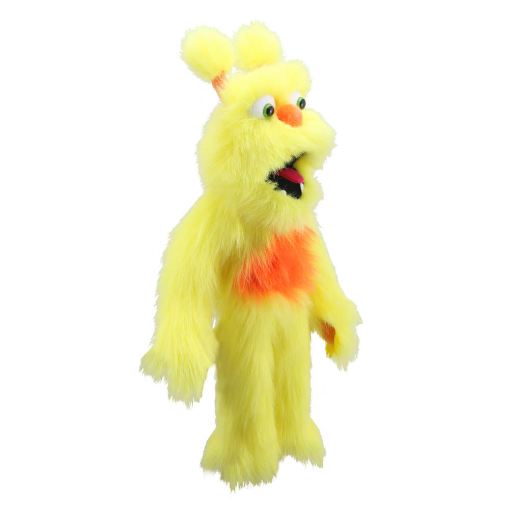 A yellow furry monster puppet or plush character with orange chest details, a pointed orange nose, and a wide open mouth showing black and red interior, isolated on a white background.