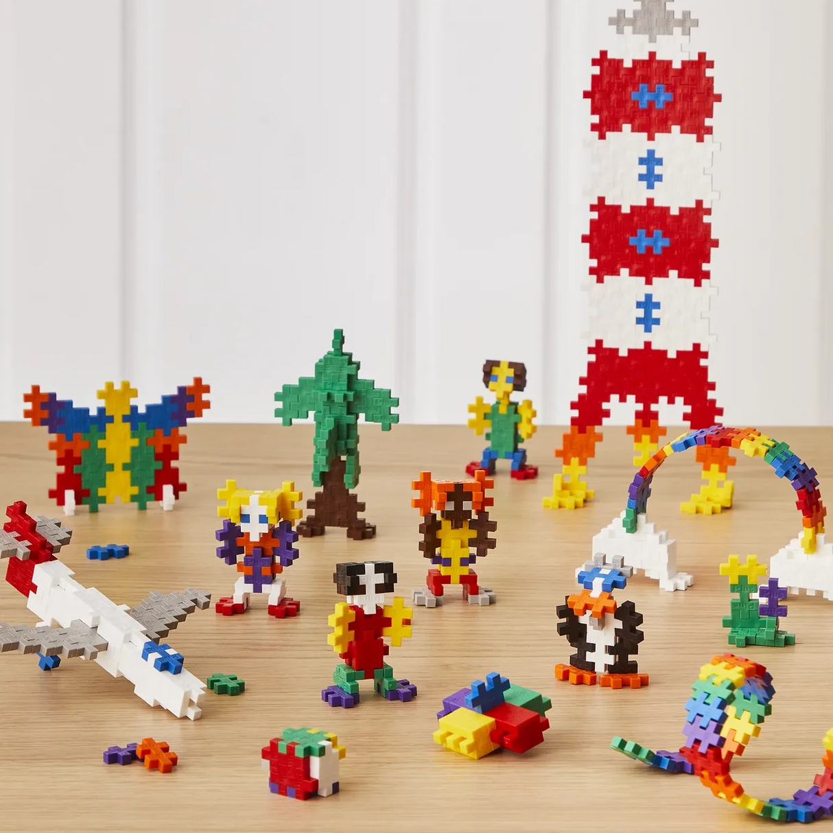 Colorful building block toys on a wooden surface with a white background