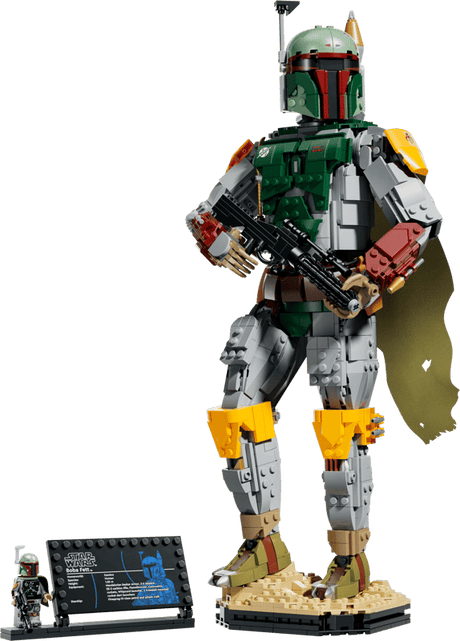 Lego Star Wars The Mandalorian Boba Fett set featuring a detailed Boba Fett action figure with a green and silver armor suit, yellow accents, a black blaster, and a gold drape, standing on a display base with a small minifigure and an informational plaque against a solid green background.