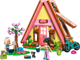Toy house with two dolls, a cat, and various accessories on a transparent background
