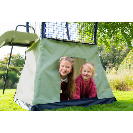 Two children peeking out from a green tent attached to a playset.