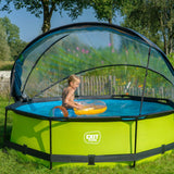 Green inflatable pool with canopy in a garden setting