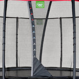 Trampoline with safety net and EXIT Toys logo on a gray background