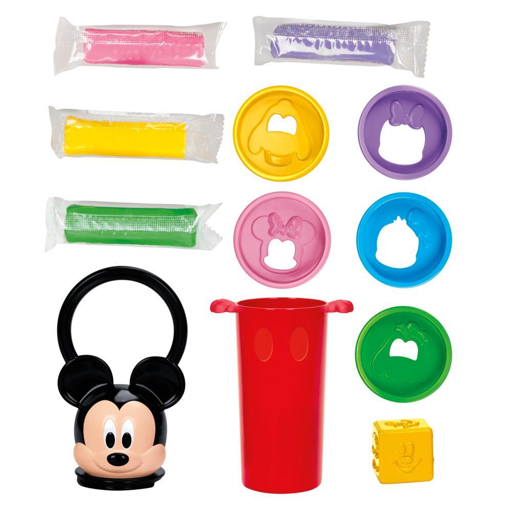 Collection of colorful children's toys including a red cup, Mickey Mouse-shaped bottle, and various shaped molds on a white background.