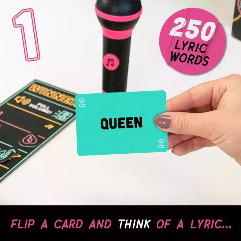 A hand holds a turquoise card labeled 'QUEEN' in front of a black and pink microphone and a lyric card. Pink text badges read '1', '250 LYRIC WORDS', and 'FLIP A CARD AND THINK OF A LYRIC.