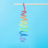 Colorful beaded spiral on a stick against a blue background