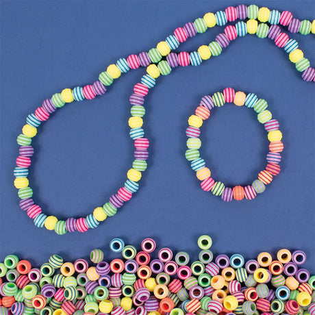 Colorful beaded necklace and bracelet on a blue background