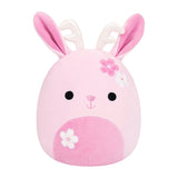 A pink plush bunny toy with long pink ears, white inner ears, embroidered black eyes, a small pink stitched nose, and white and pink flower accents on the head and snout, shown on a plain white background.