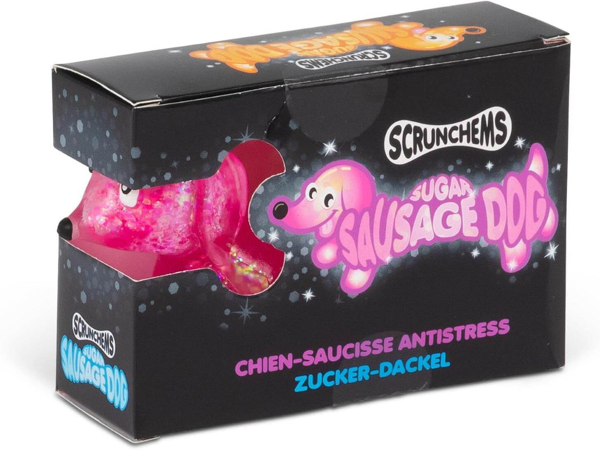 Scrunchems Sugar Sausage Dog toy packaging box, featuring a black box with a clear window showing a pink glittery sausage-shaped dog toy inside.