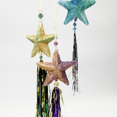 Decorative hanging stars with tassels on a white background