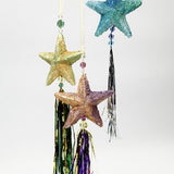 Decorative hanging stars with tassels on a white background