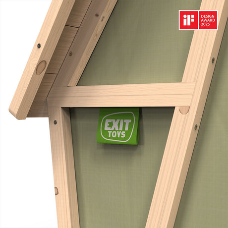 Wooden playhouse with green door and Exit Toys logo, featuring a Design Award 2025 badge.
